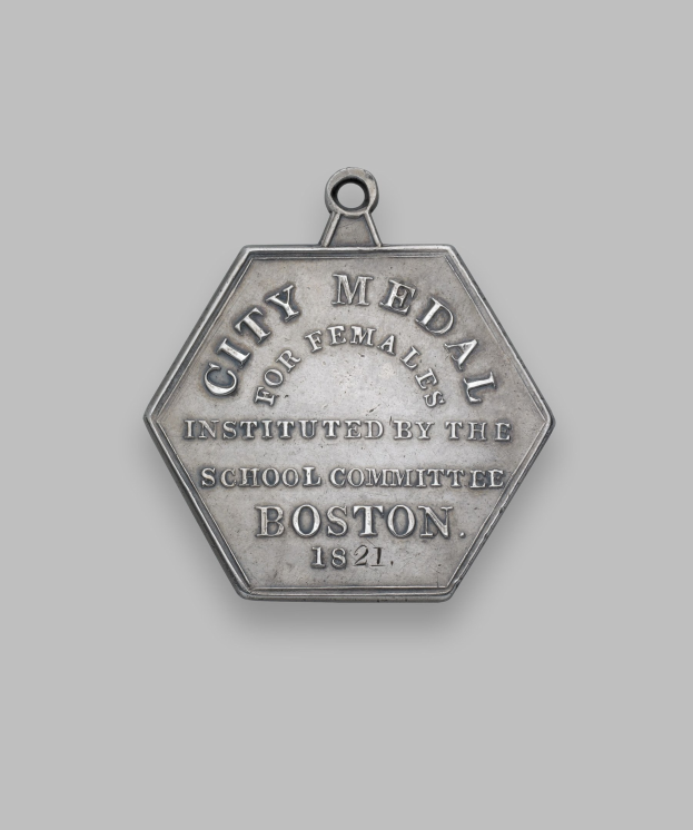 Silberne Medaille mit der Aufschrift 'Stadtmedaille für Frauen' vor weißem Hintergrund.