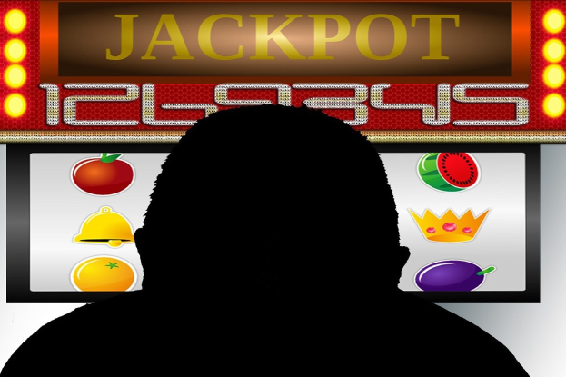 Ein Mann spielt an einem Automaten mit 'Jackpot' auf dem Display, umgeben von einer Tafel mit Text und Obstbildern, was auf ein Online-Casinospiel hindeutet.